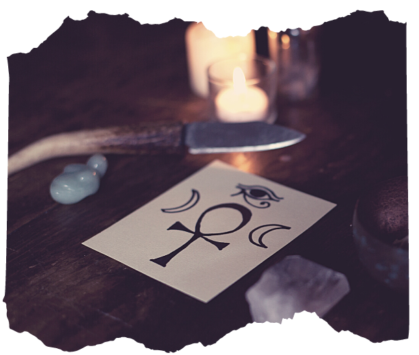 Card with ankh, Eye of Horus and crescent moon symbols on a candlelit altar — magical symbols and bonus resources in Way of the Mage