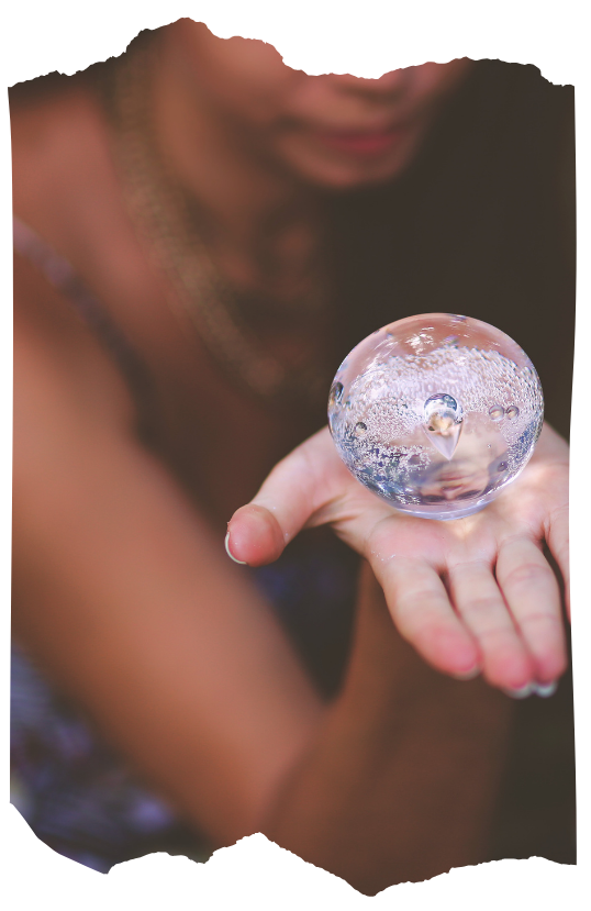 Hands holding a crystal ball during a scrying ritual