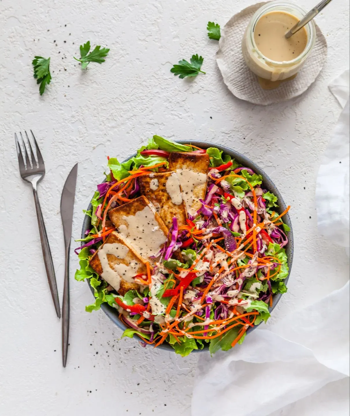 Fresh chopped Salad with Tasty Tofu and Tahini Dressing