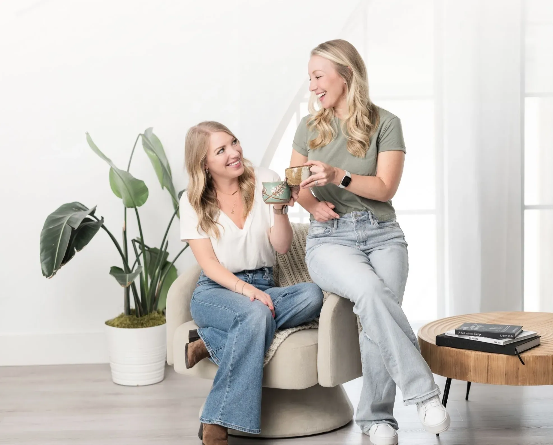 Claire VanBemmelen and Krissy Chin cheersing with mugs after successfully working on website copywriting and messaging strategy as part of K+C Creative brand clarity process.