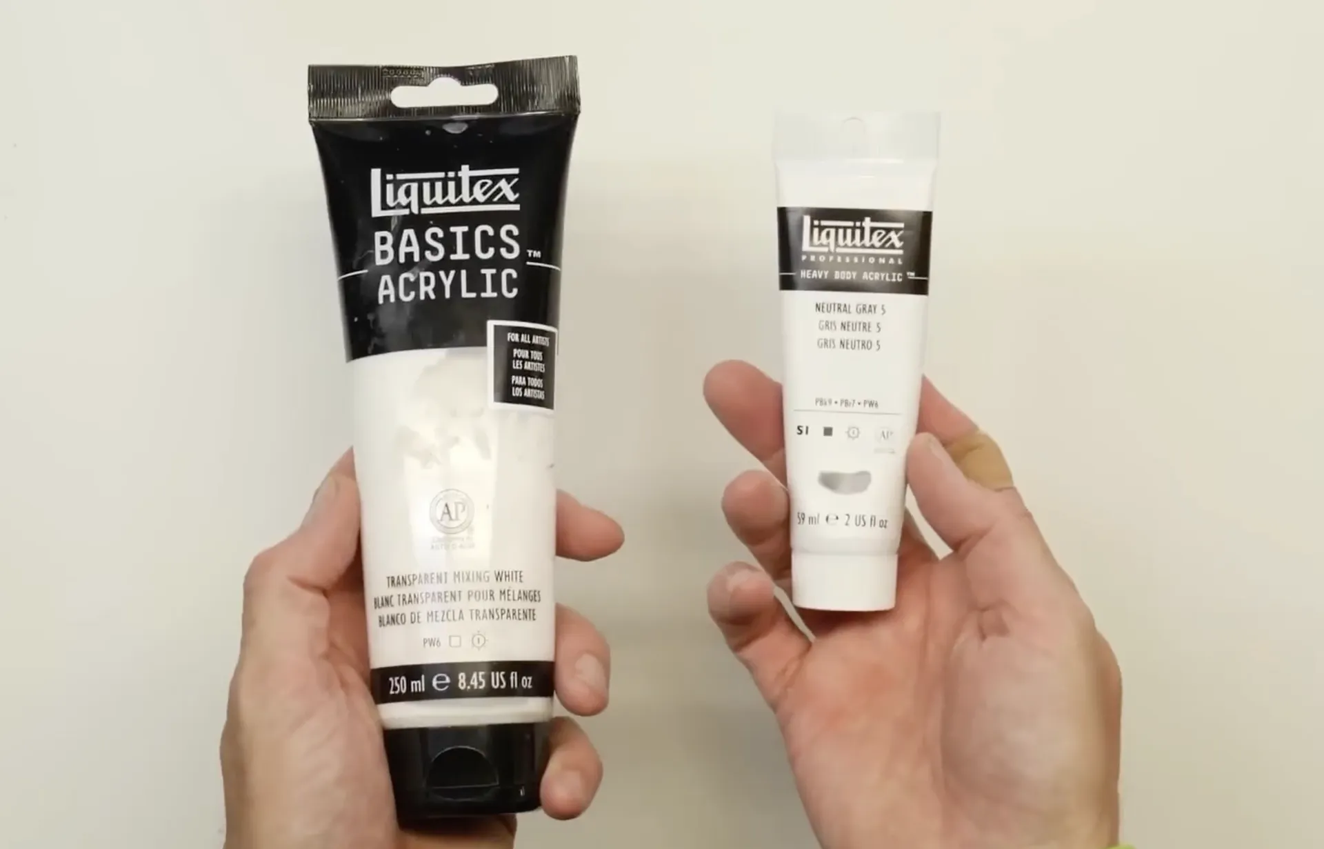 Student grade and artist grade acrylic paint tubes compared side by side
