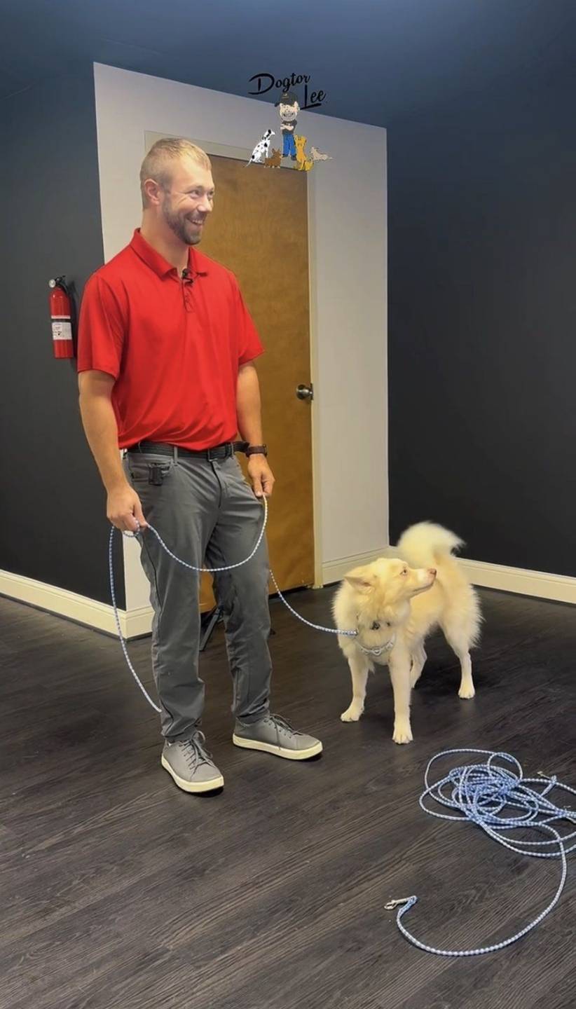 Lee in a red shirt with a husky