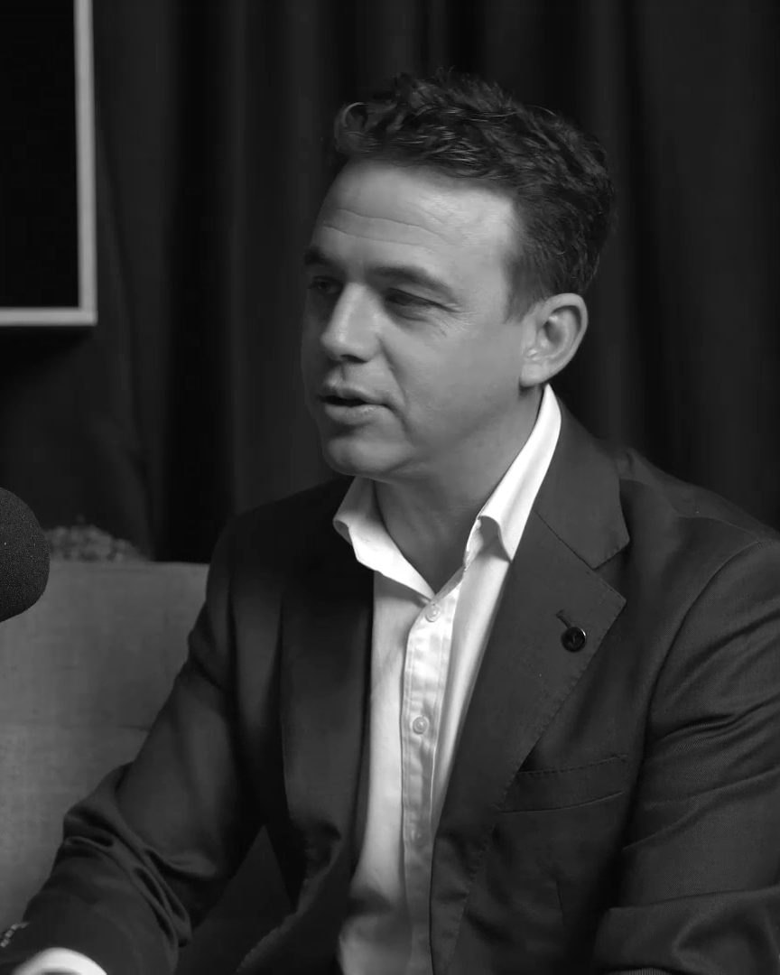 Aaron Shiner mid-conversation in a podcast studio