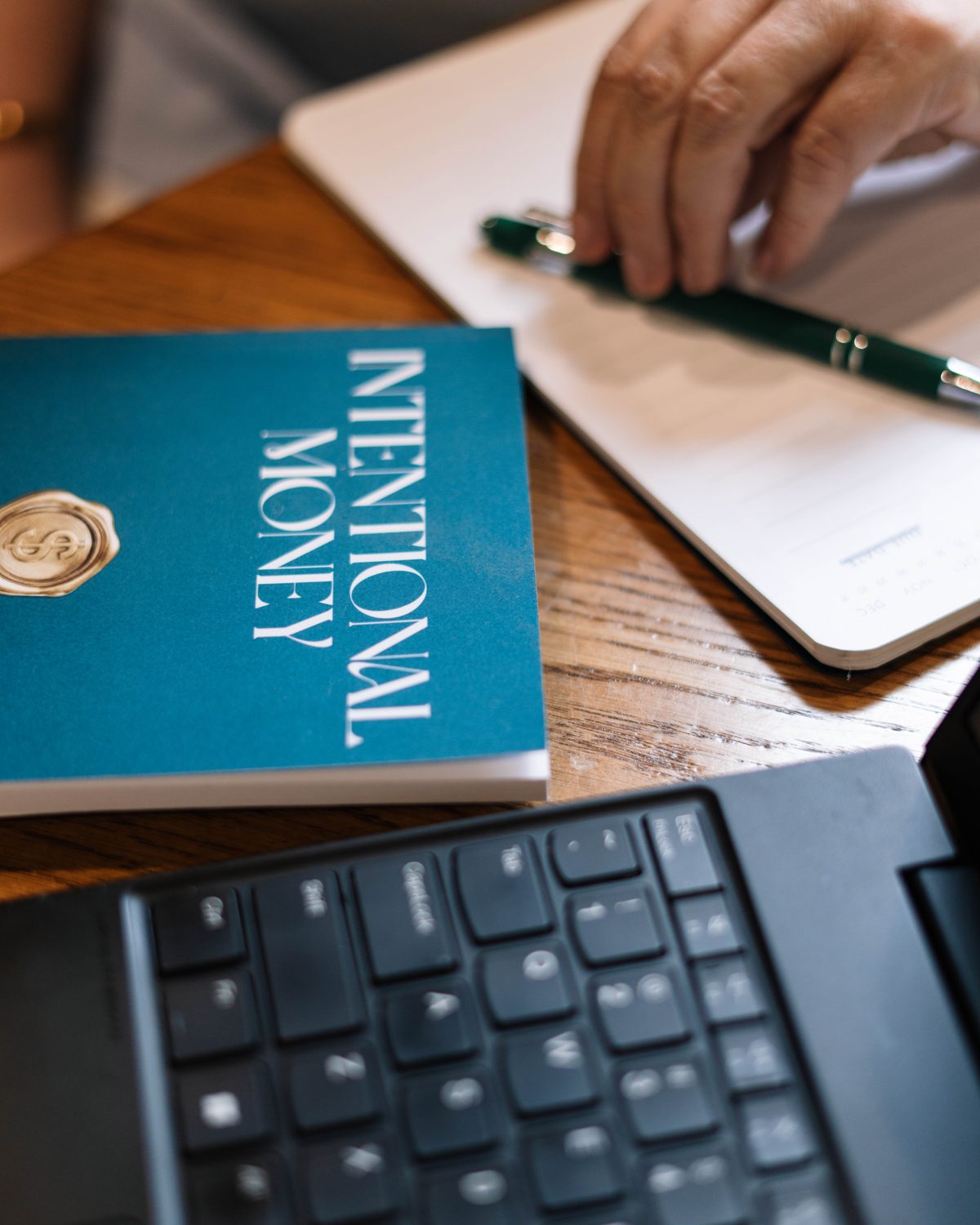Intentional Money book beside a notebook and pen