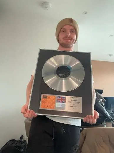 Vibe Chemistry holding a platinum disc