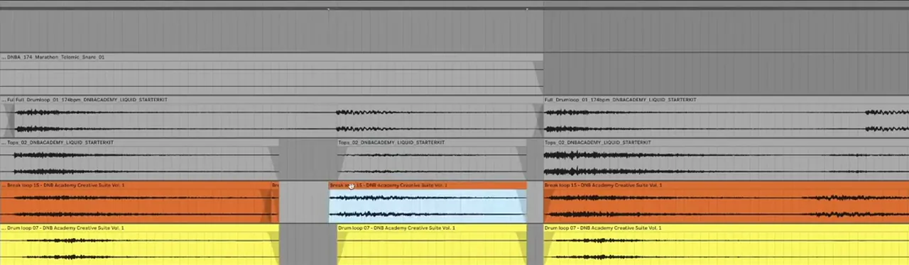 Ableton Live arrangement zoomed in on layered liquid DnB loops, with one hit sliced out of the break and drum loop and moved to line up with a swung drum loop