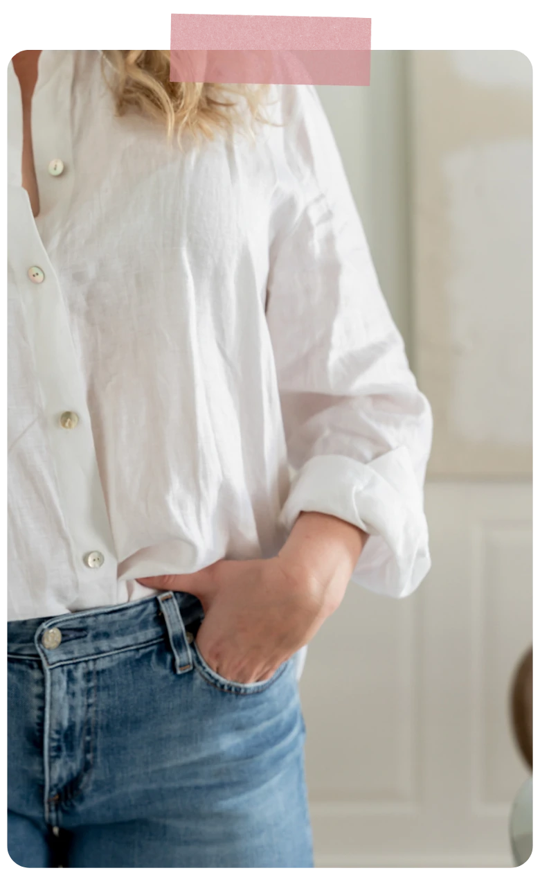 Woman in a white shirt and jeans, with pink tape