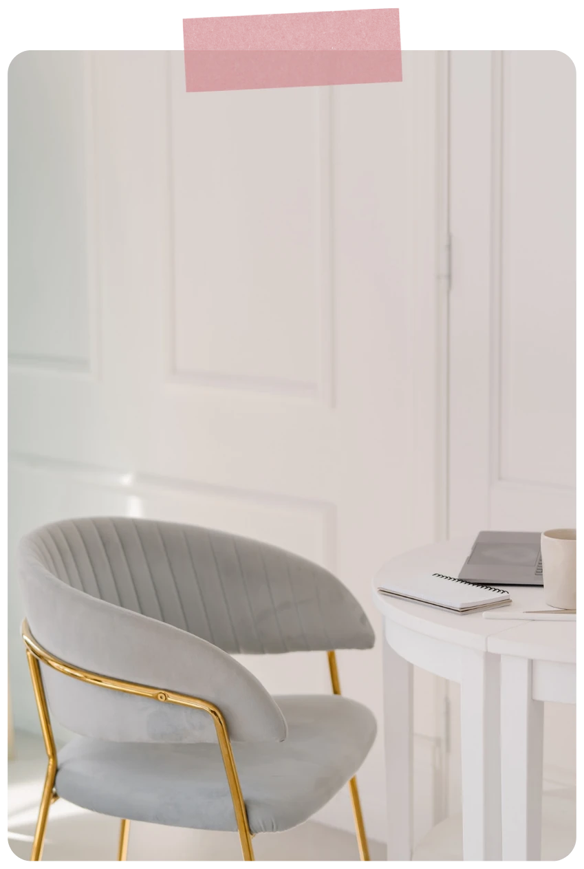 Empty chair beside a desk, with pink tape