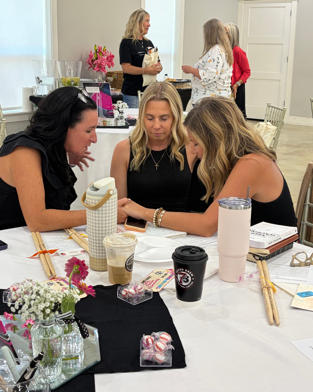 Women praying together at a Faith Filled Entrepreneur event