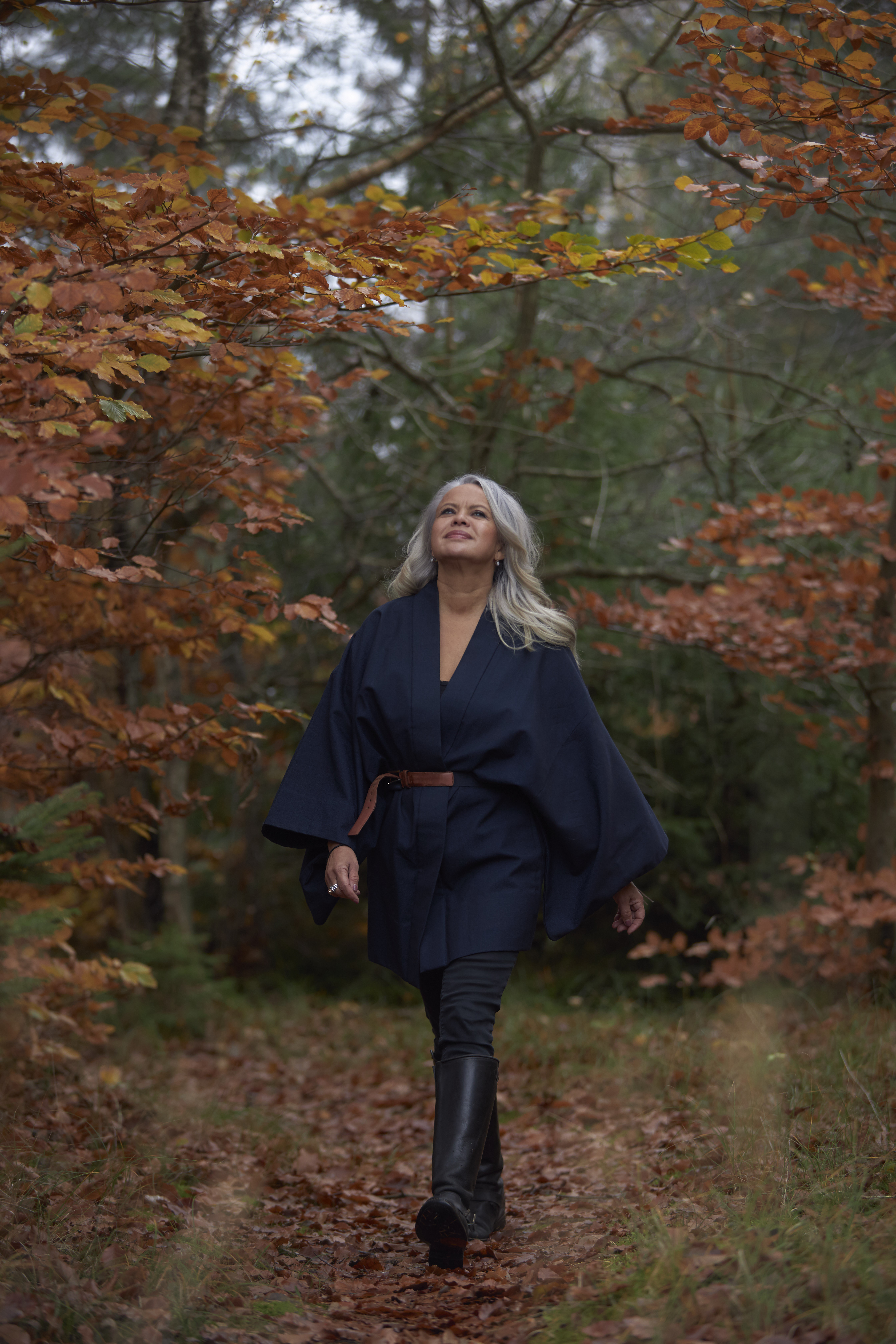 Lucy Vittrup Christensen walking through an autumn forest
