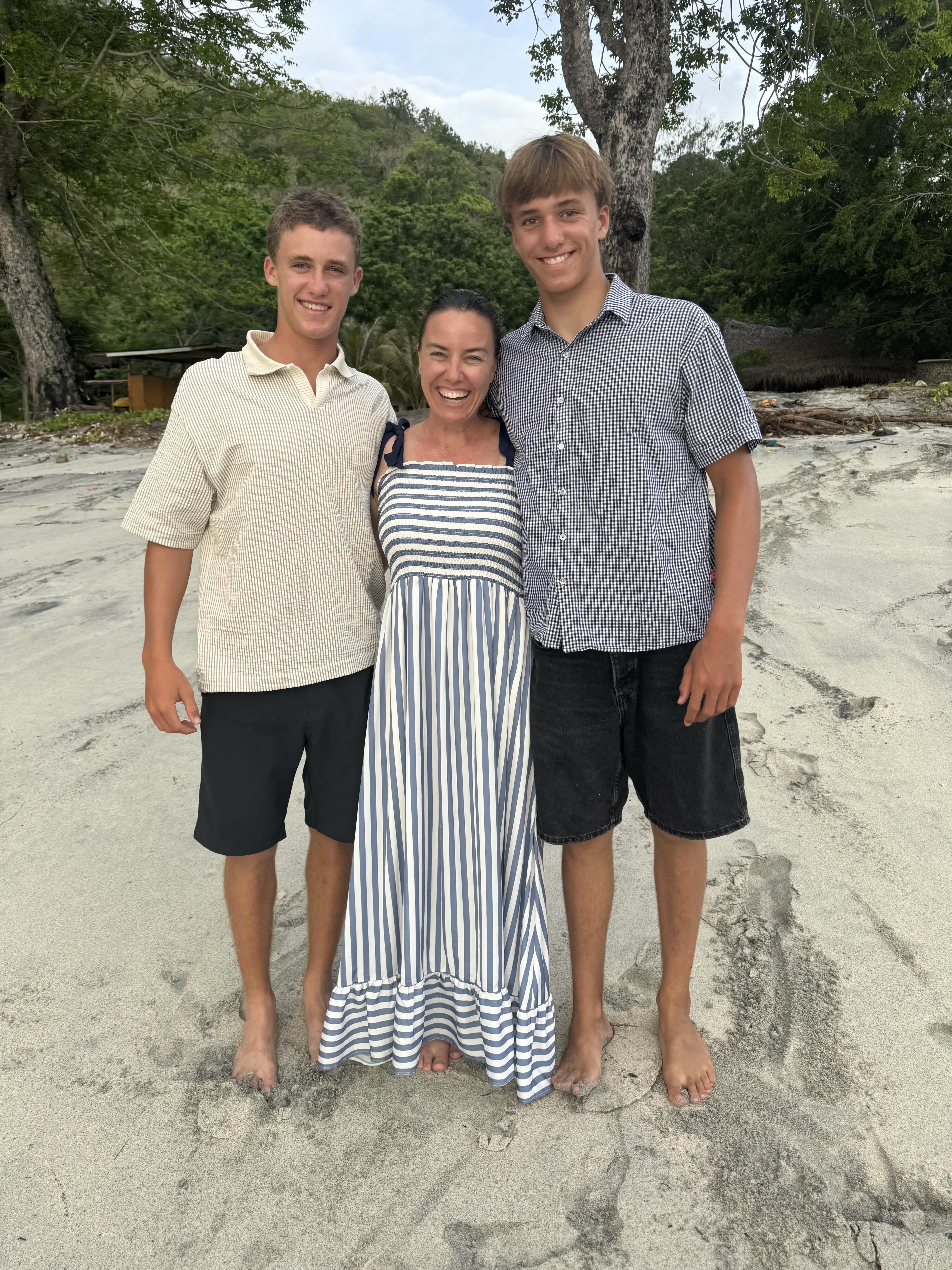 Tina with her two sons, now young men, on the beach