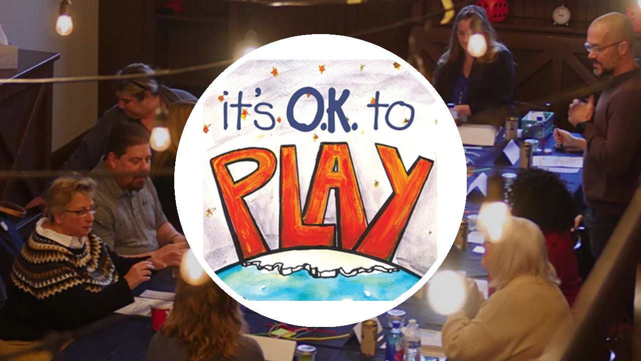 Hands painted with colorful letters spelling "PLAY," representing DillonMarcus' It's O.K. to Play! training module