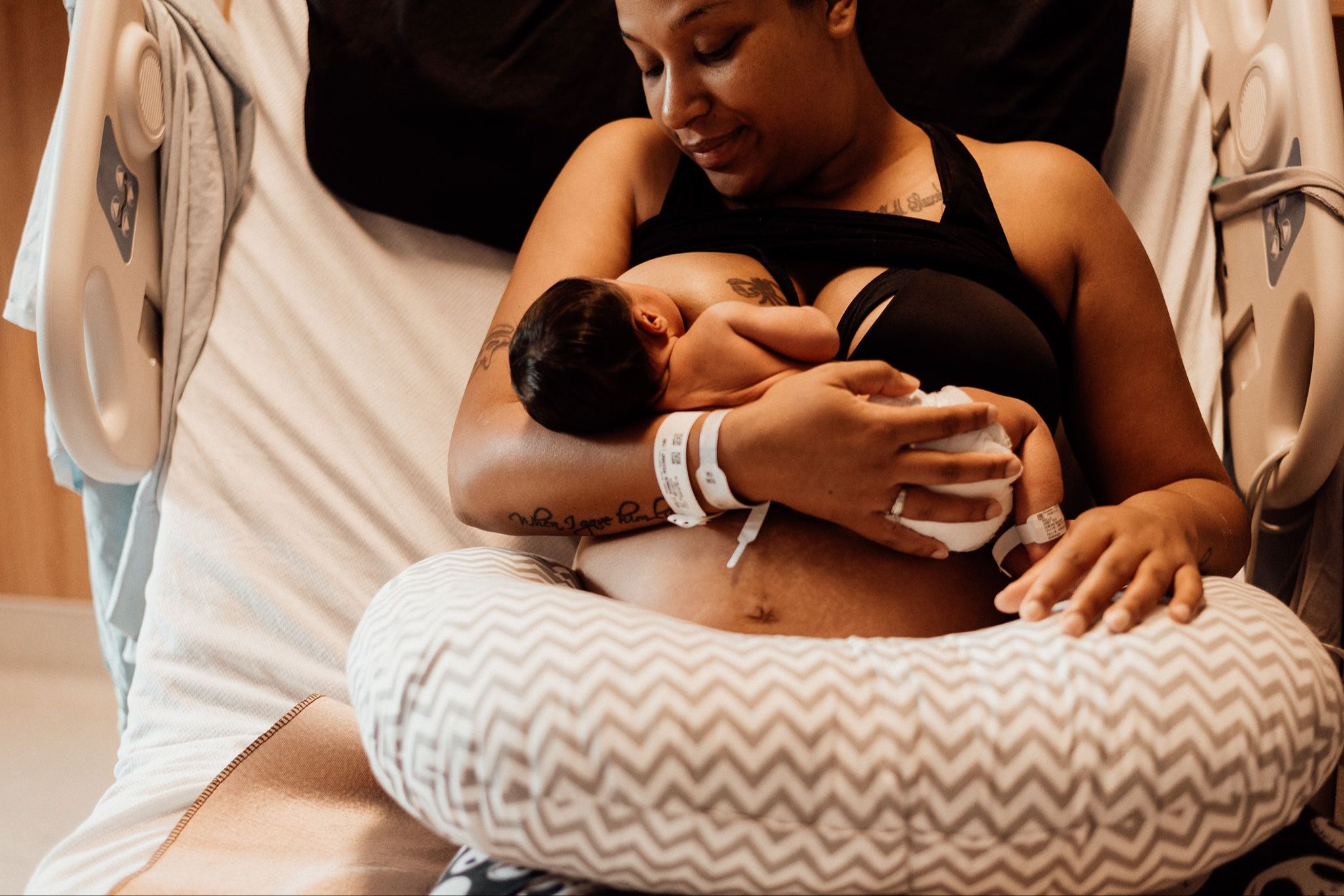 Mother breastfeeding newborn baby in hospital