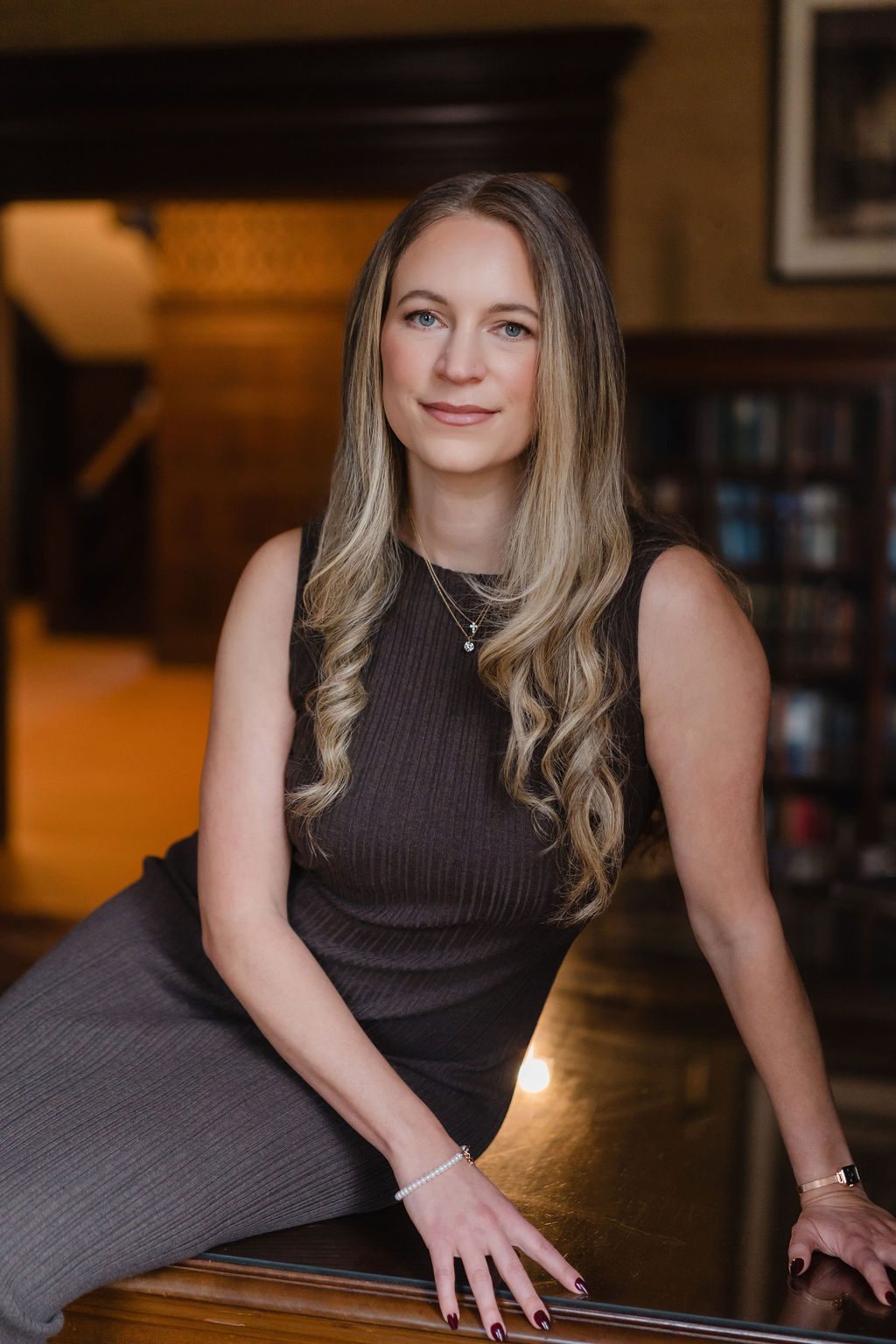 Laura seated in a library