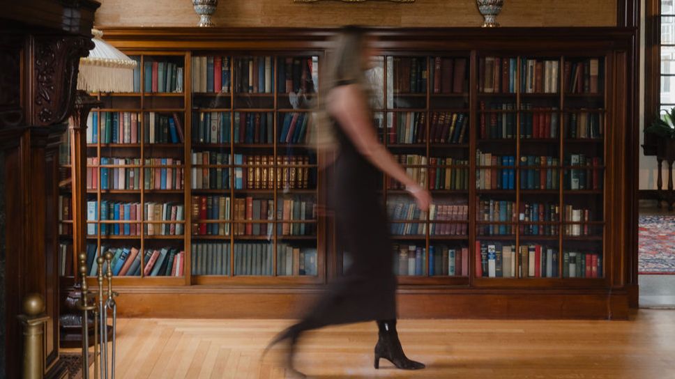 Laura walking through a library