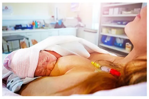 Newborn baby breastfeeding while in hospital