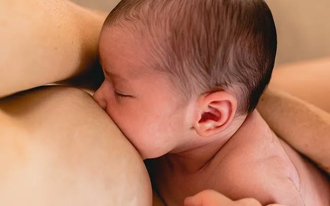 Up close photo of breastfeeding baby