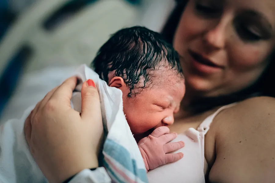Newborn baby on mother after giving birth