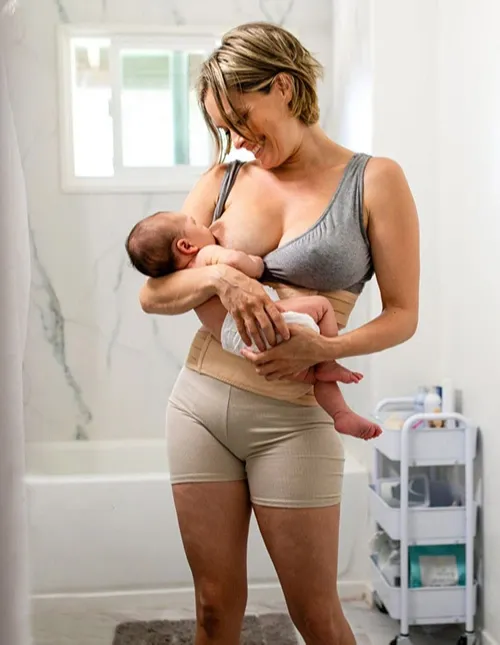 Mother Breastfeeding Her Baby Smiling