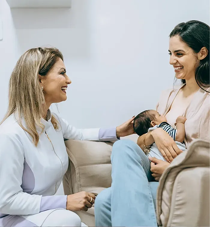Thompson Method Practitioner Helping Mother Breastfeed