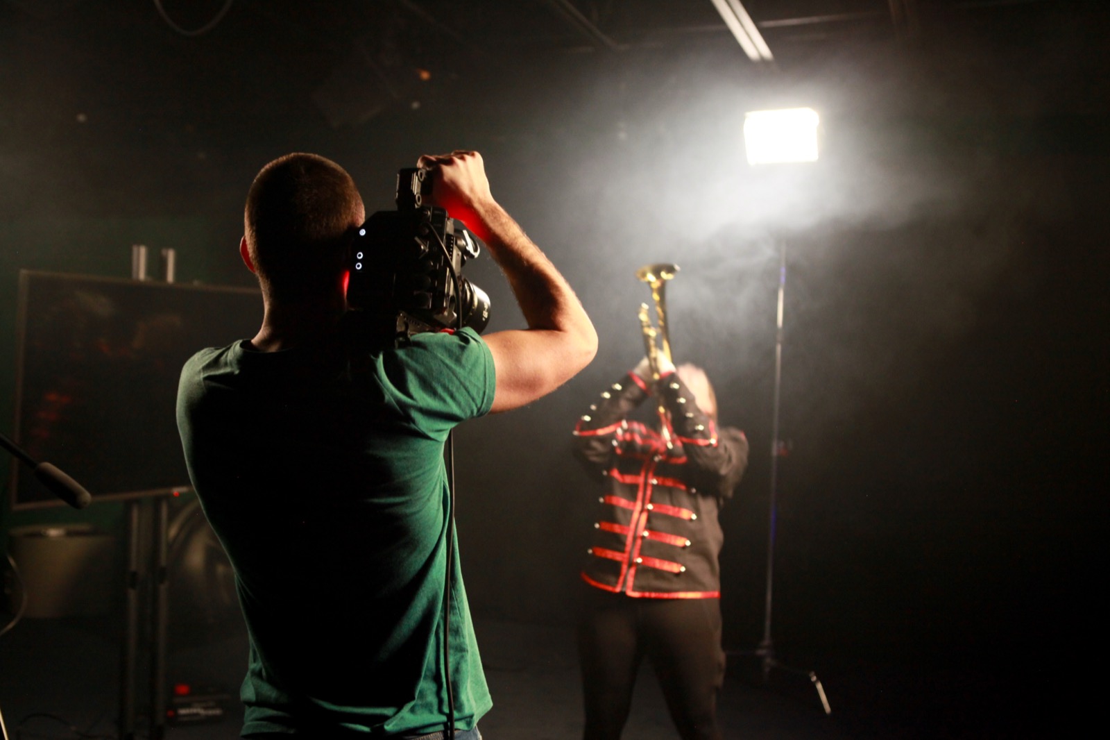 Camera operator filming a musician on a VIVA studio stage