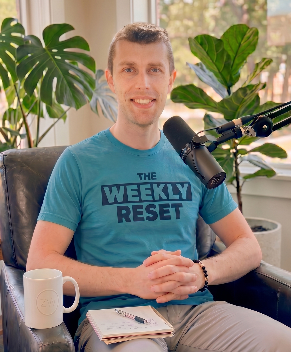Photo of Zac in a chair with laptop