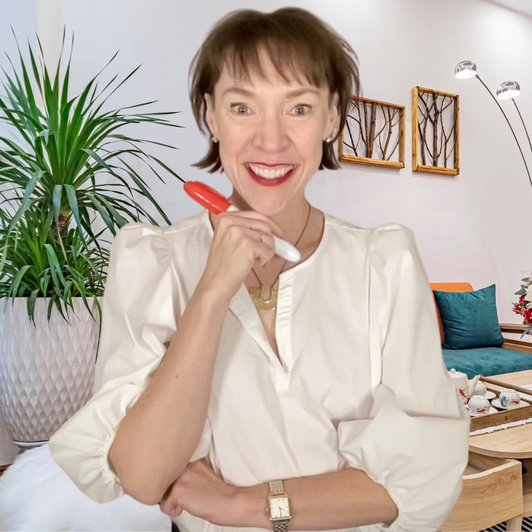 Penny is smiling and holding a red marker