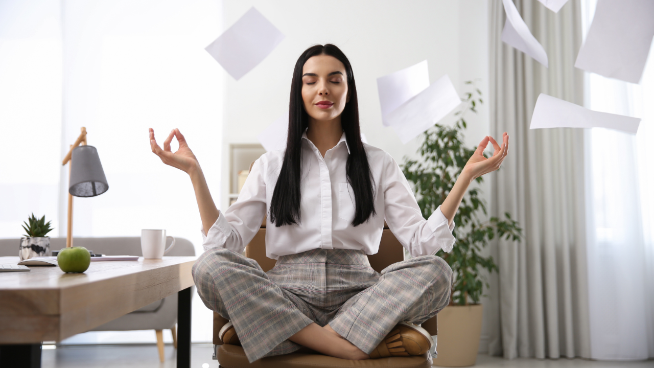 A business woman sits in a yoga pose