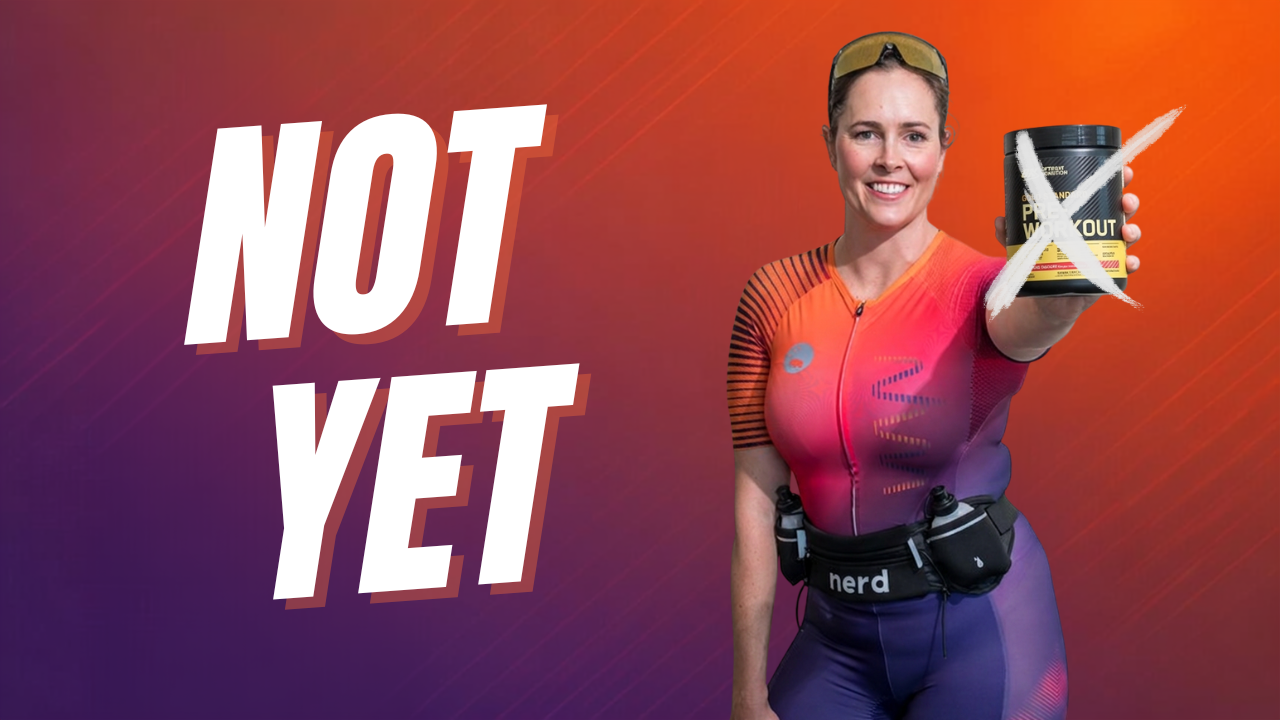Triathlete drinking from a bottle on the bike, illustrating hydration in triathlon nutrition priorities