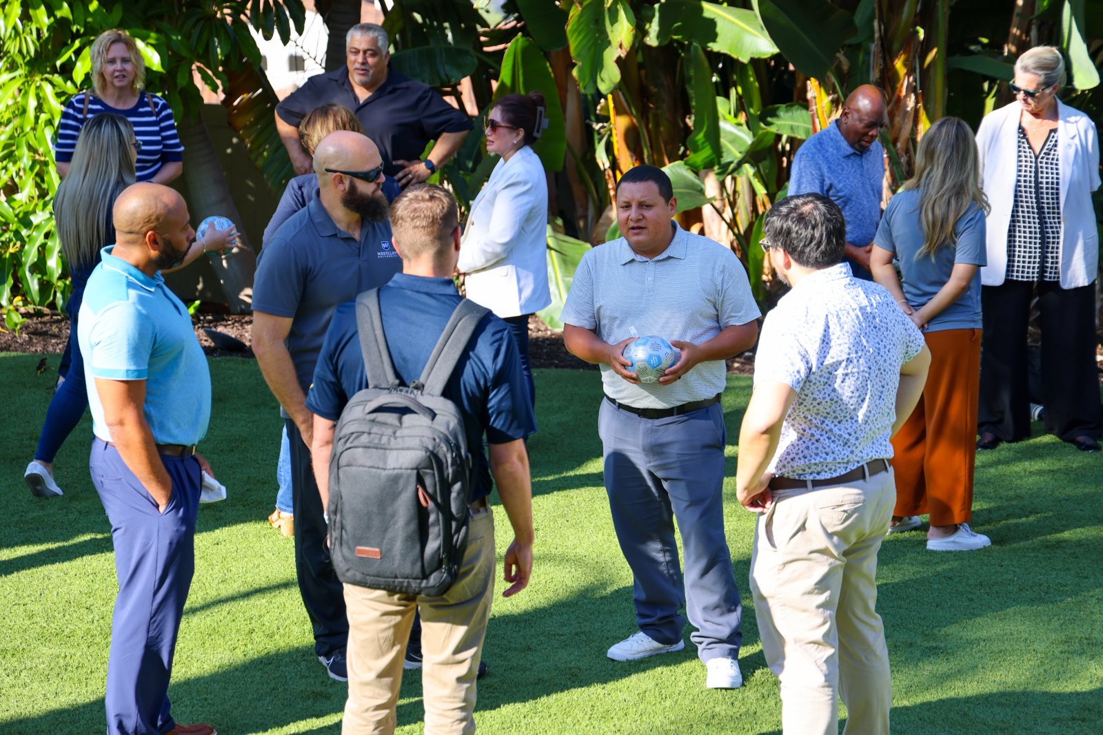 Leaders talking together outdoors during a team activity at a retreat