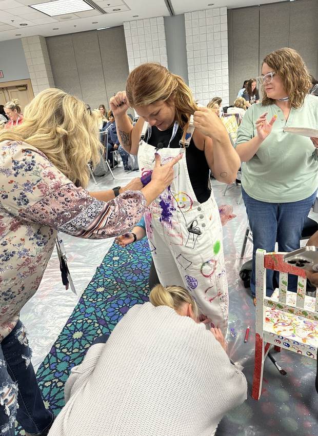 Teachers getting messy and creative during a hands-on play workshop