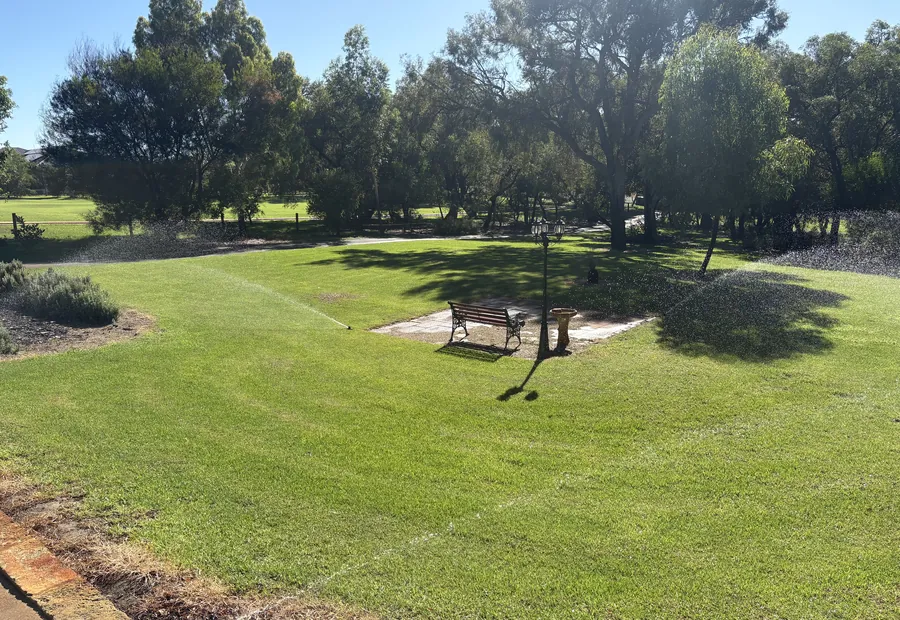 Sprinklers providing even coverage across a healthy lawn