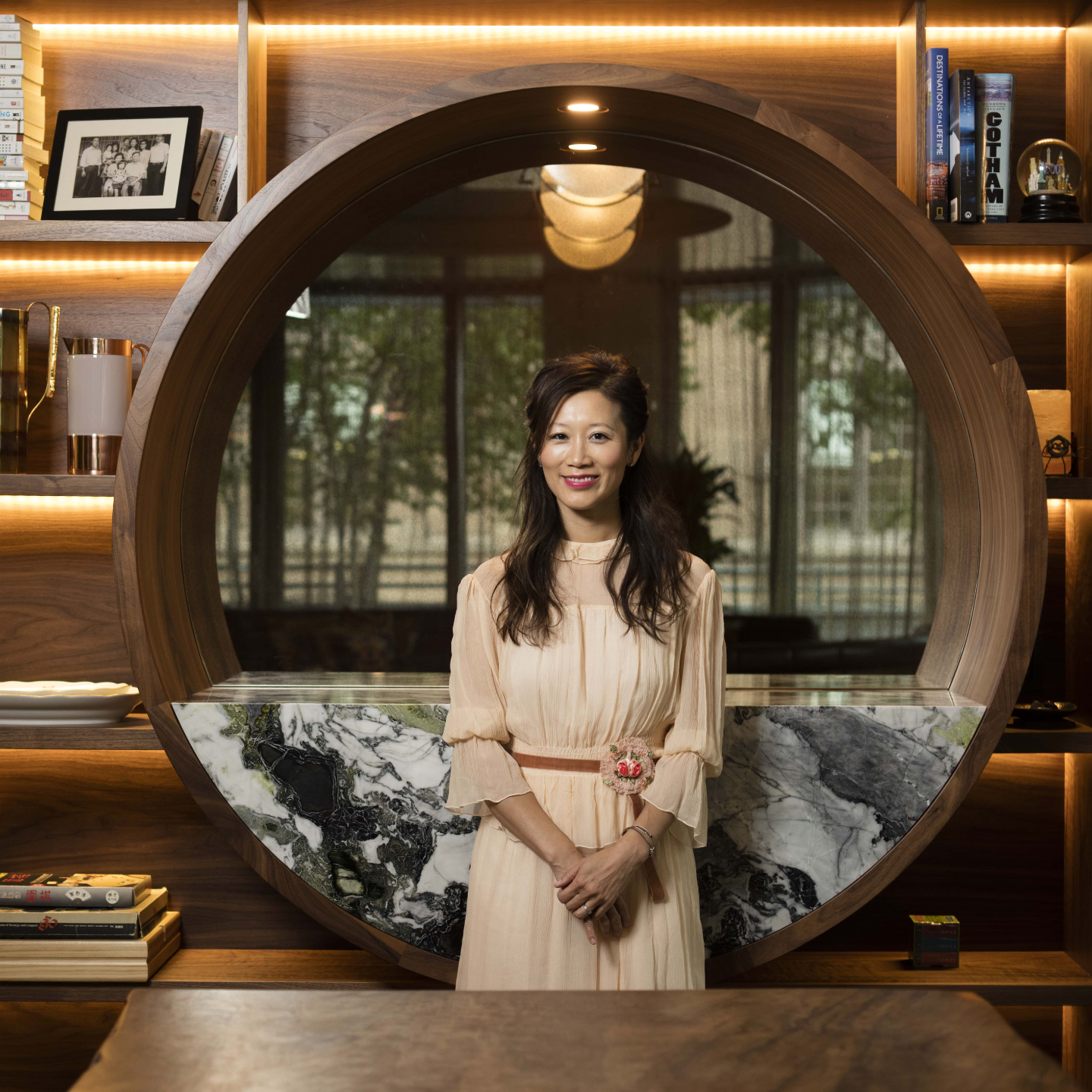 Sophia Ruan Gushee standing in her living room, in front of a circular mirror