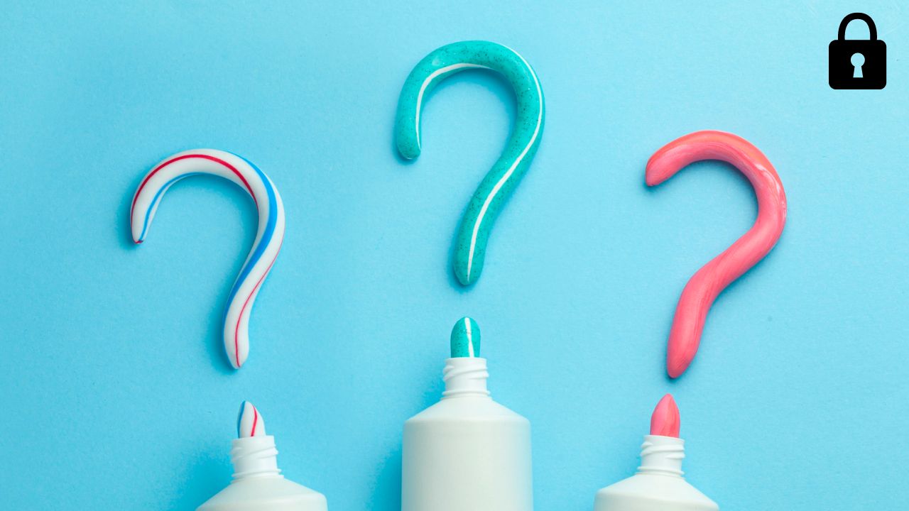 Three white tubes, against blue background, squeezing out question marks with artificial colors, representing artificial colors