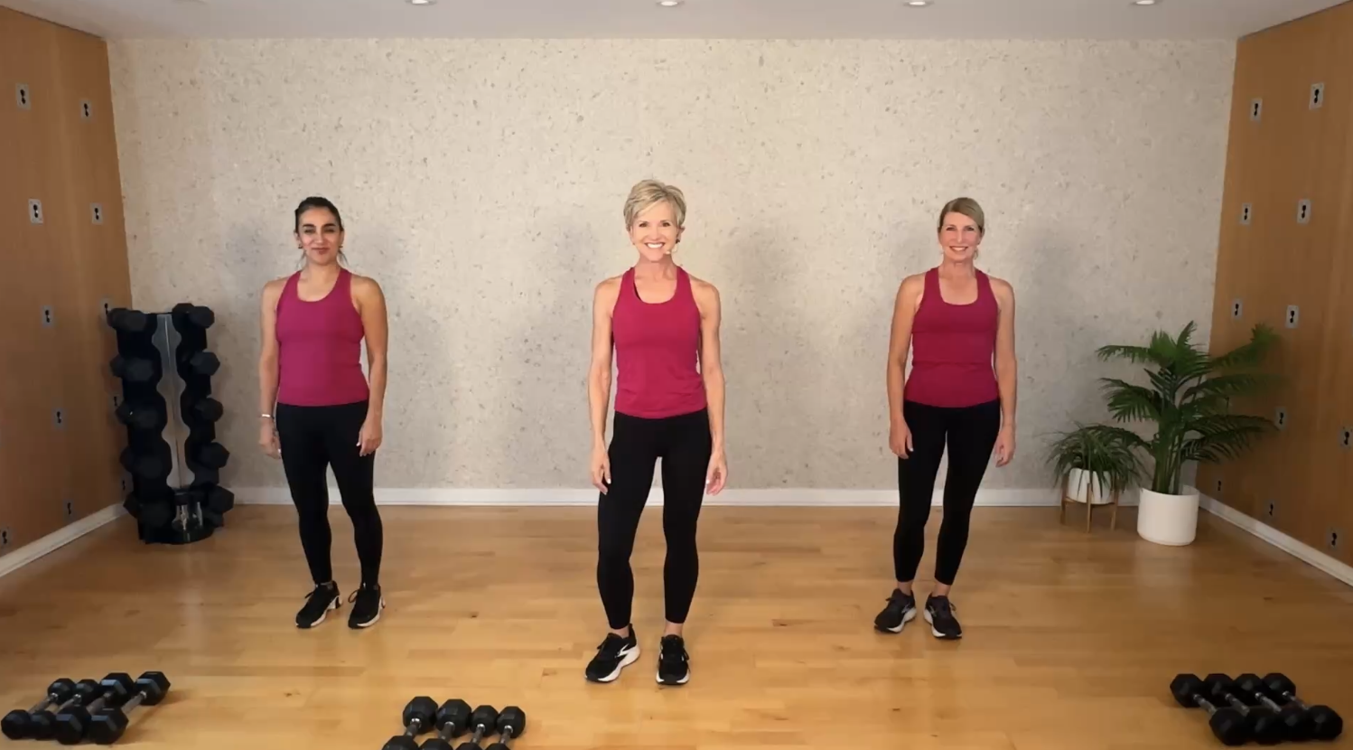 Michelle Dozois and two exercisers smiling at the start of a Build Momentum workout