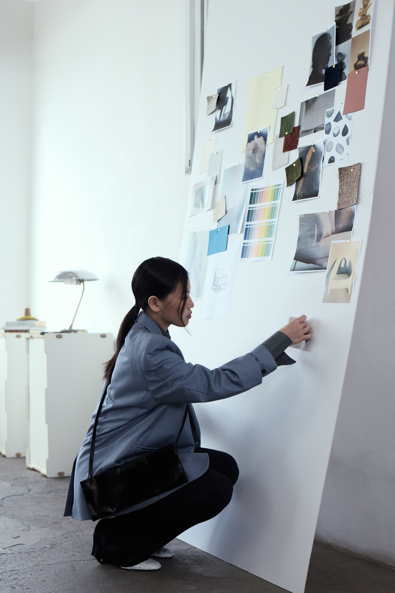 Designer pinning swatches to a brand moodboard