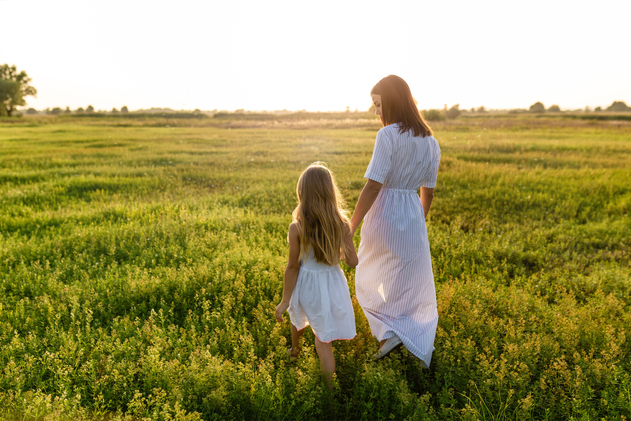 A mother and daughter together in open fields