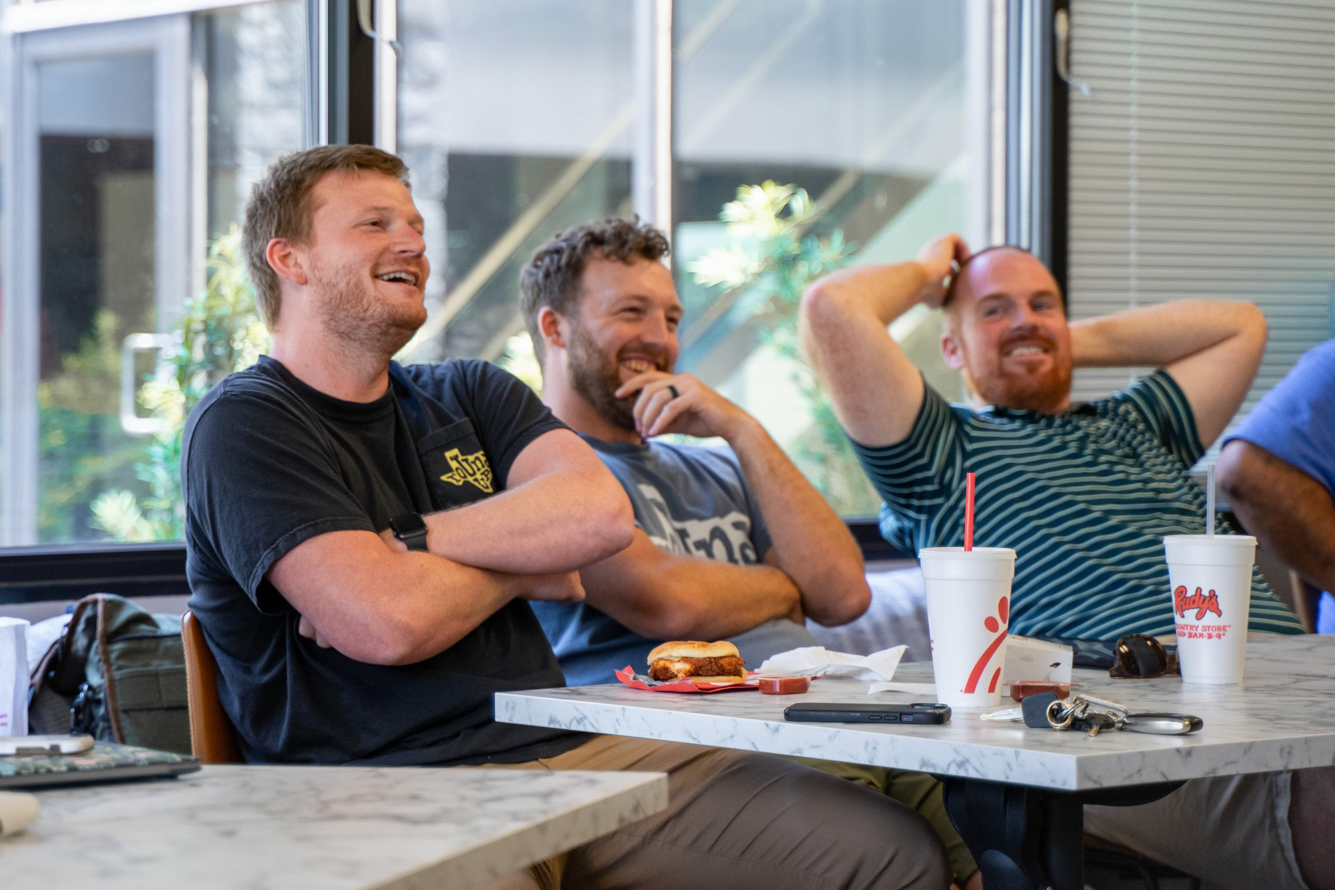 Pastors laughing together around a table