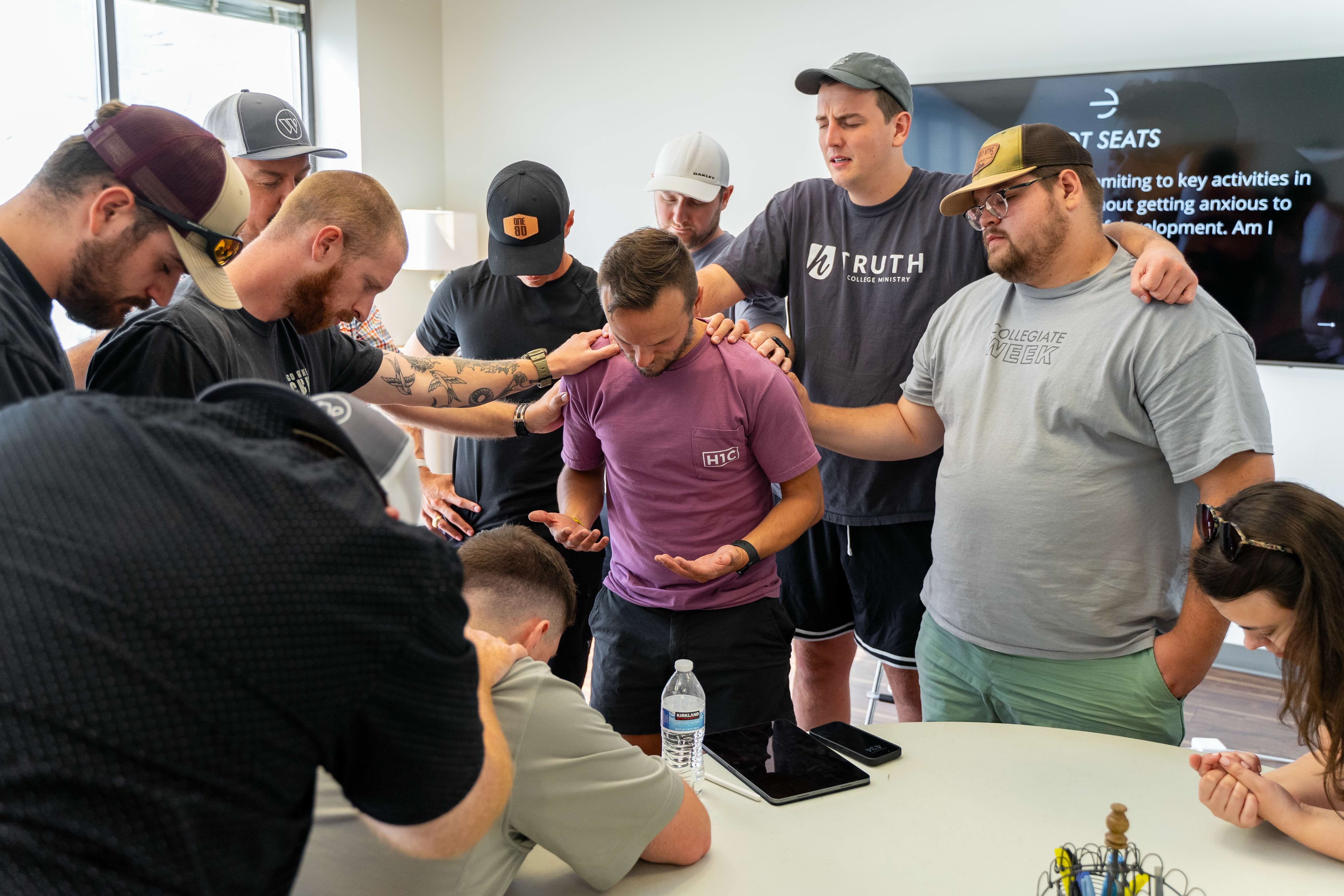 Pastors laying hands on a leader in prayer