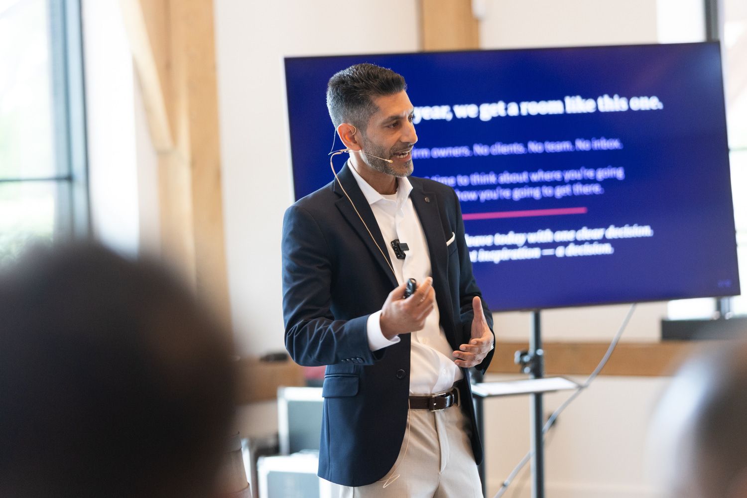 PLACEHOLDER - photo of Reza mid-talk on stage at the annual event