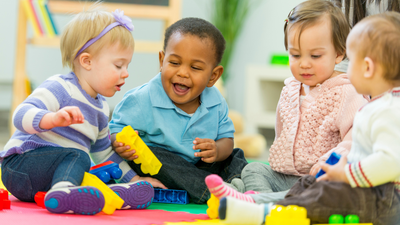 Babies sitting together during play, supporting early motor development and physiotherapy milestones.