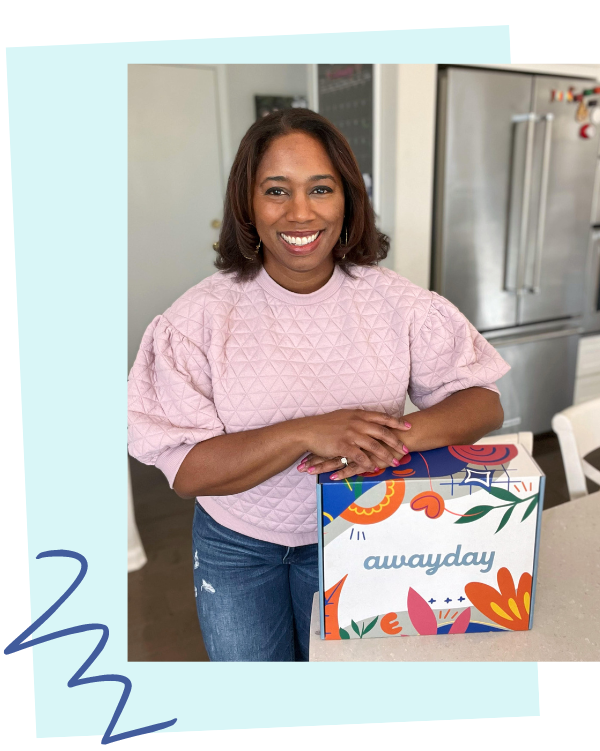 Kathy Strahs standing in a kitchen with her Away Day subscription box