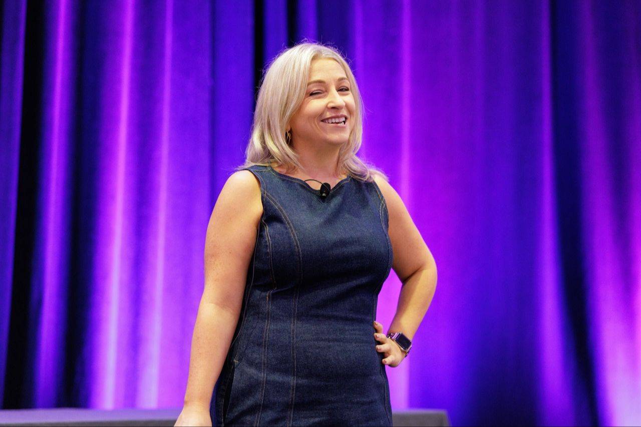 Cassandra Thompson speaking onstage during a keynote.