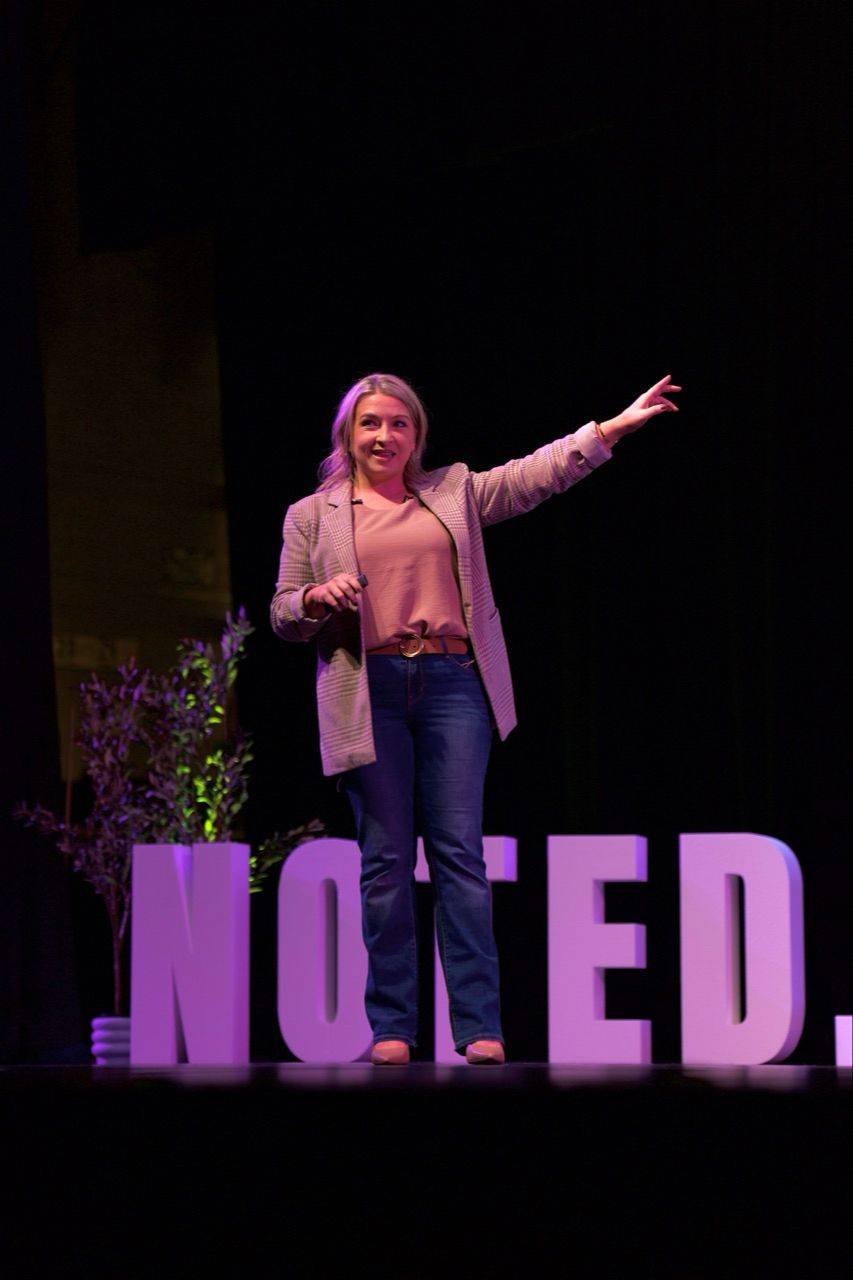 Cassandra Thompson speaking during a conference session.