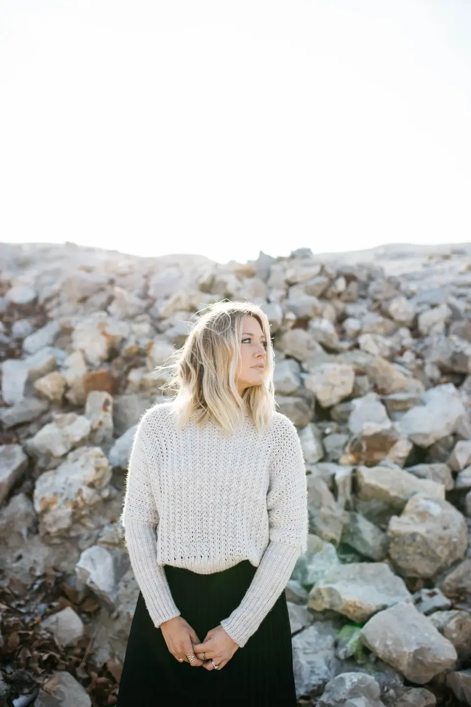 blond woman in sweater on rocky beach energy healer energy healing quantum healing