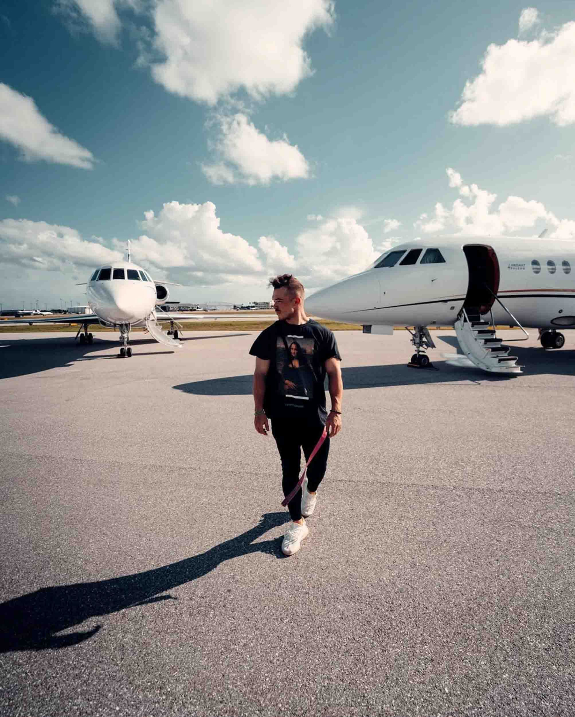 Corey Chaloff walking beside private jets