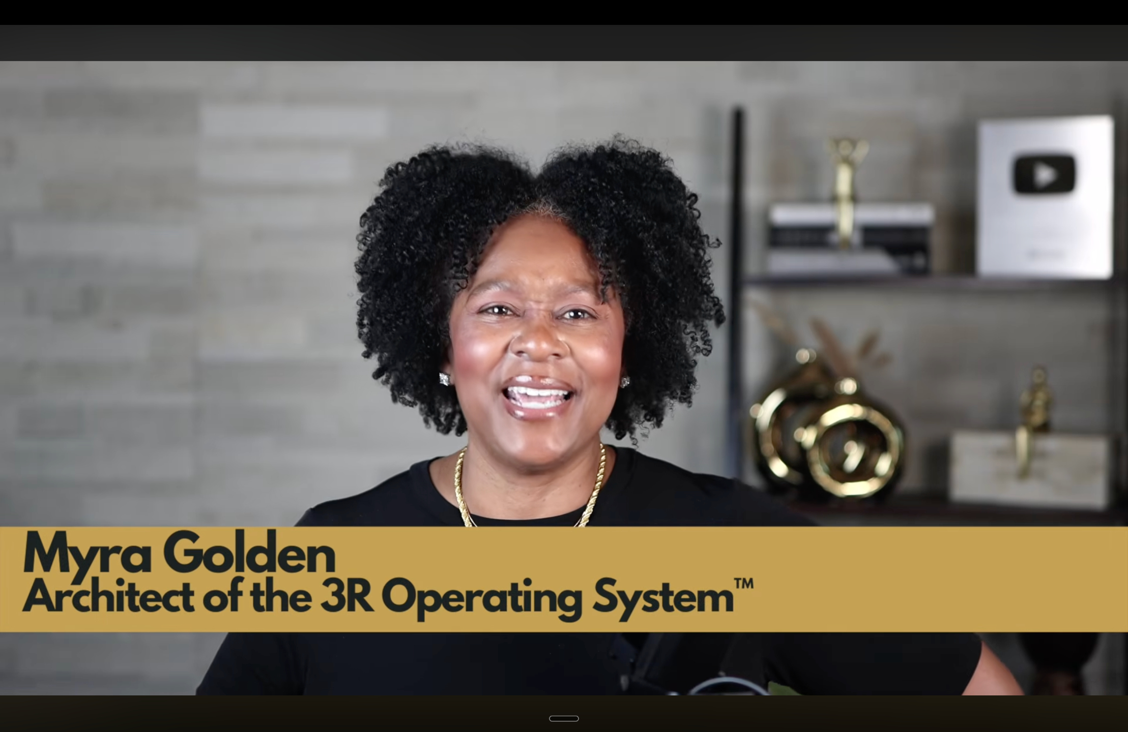 Myra Golden teaching live from her broadcast studio in Tulsa with a gold lower-third title card reading 'Architect of the 3R Operating System'