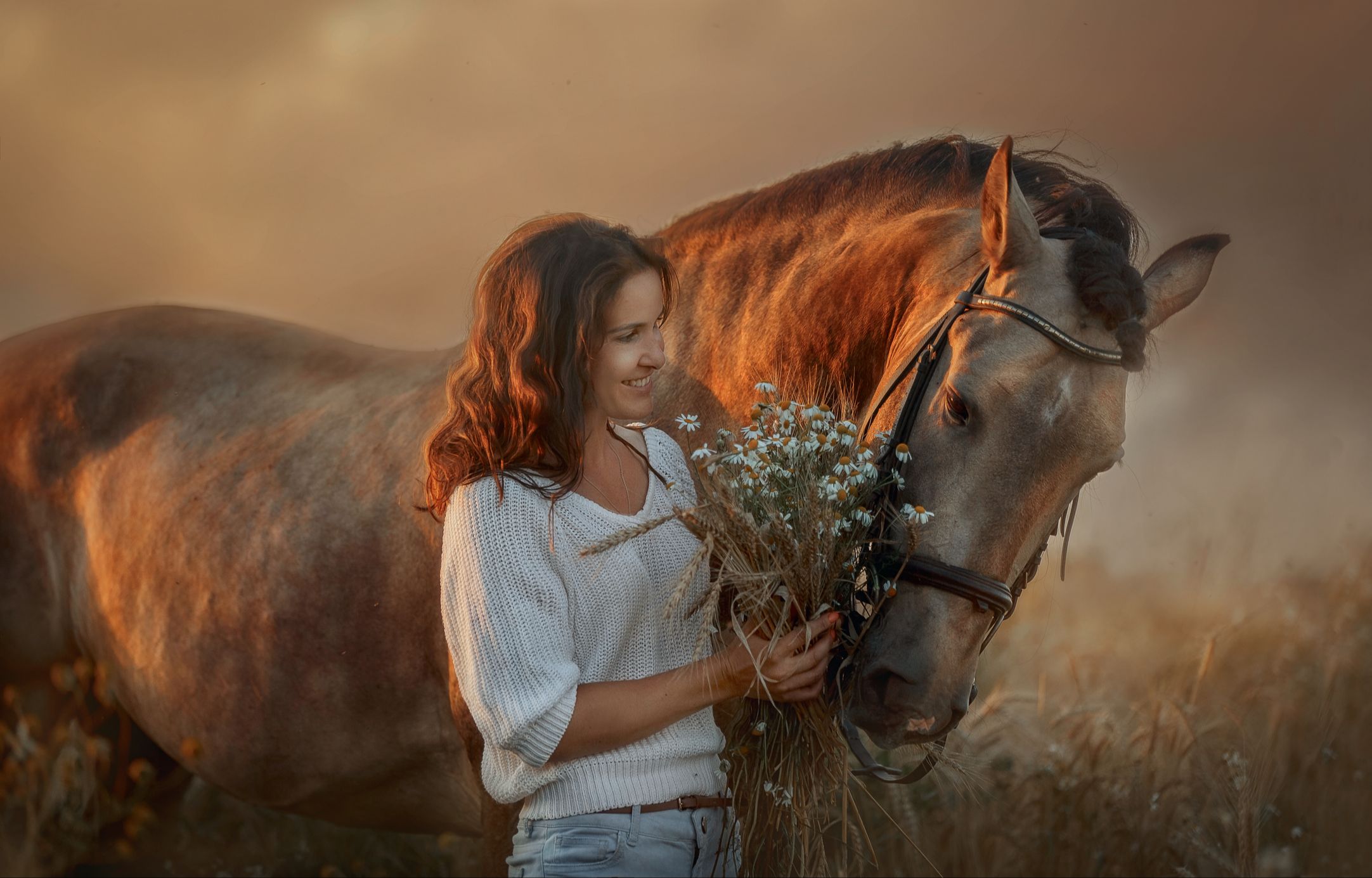 animal communication brunette woman carrying flowers with brown horse