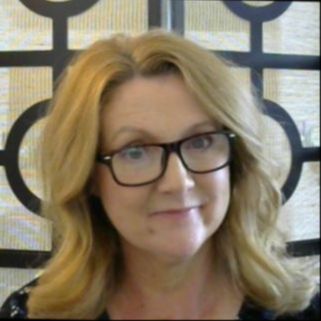 Lisa Sargent sitting at a desk wearing a 