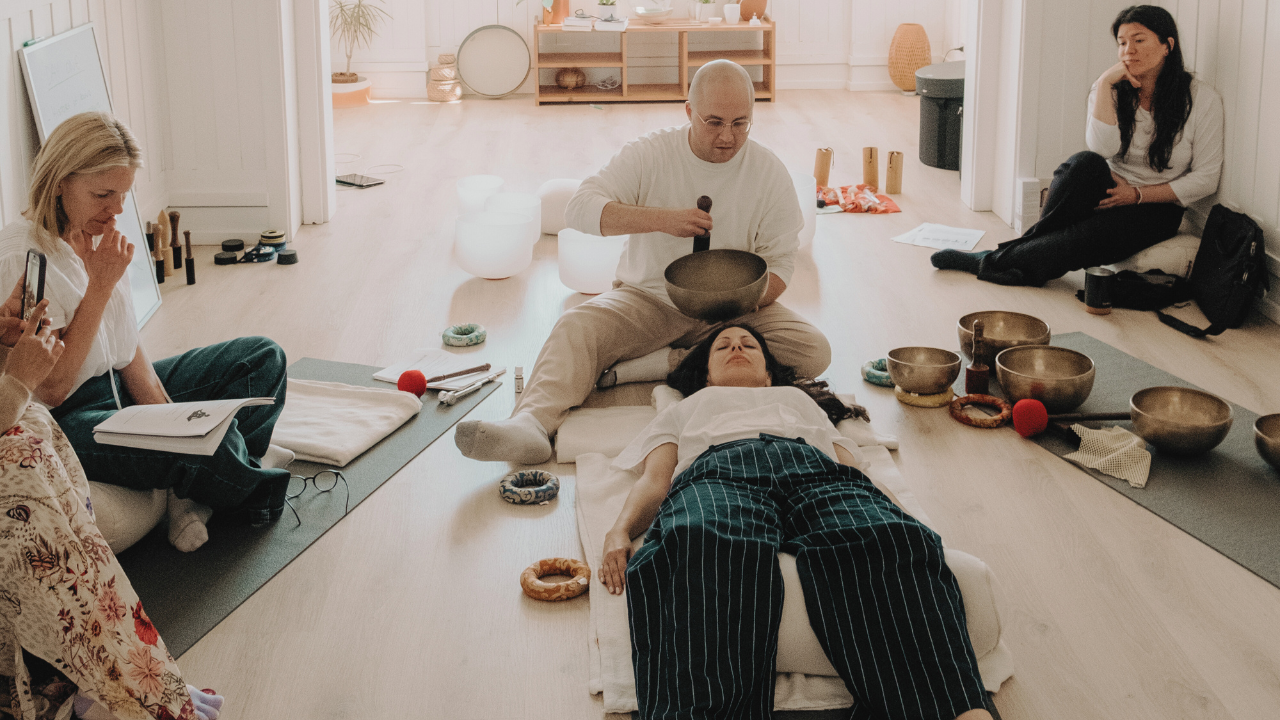 sound healing training demonstration using Himalayan singing bowls during hands-on practice